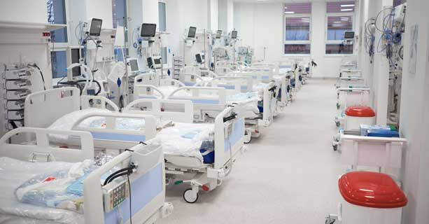 Intensive care unit filled with hospital beds and essential medical equipment