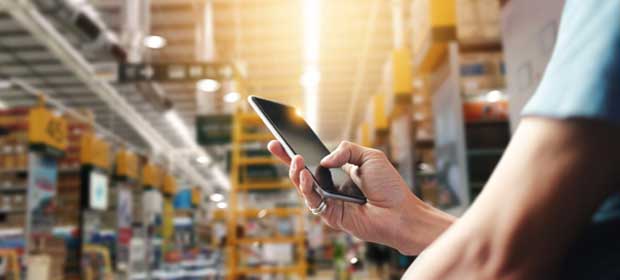 Individual on mobile phone in warehouse