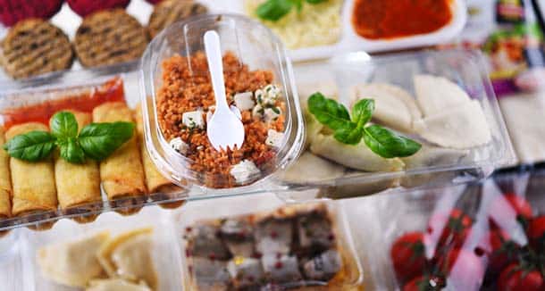 Assorted prepared foods, including snacks and meals, packaged in plastic containers